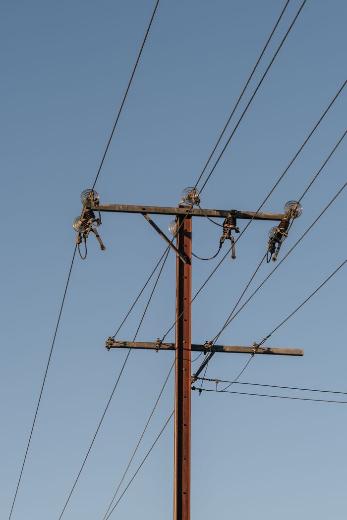 Crafting Captivating Headlines: Your awesome post title goes here High voltage electrical tower and wires under a blue sky.